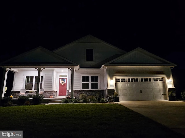 craftsman-style home featuring a garage and a yard