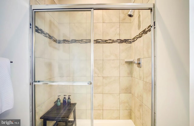 bathroom with a shower with door