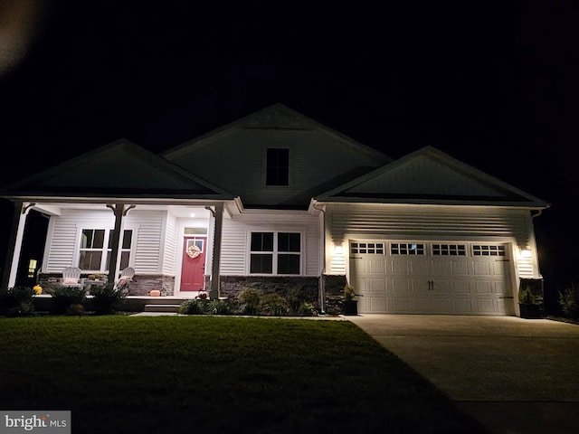 craftsman-style home with a garage and a lawn