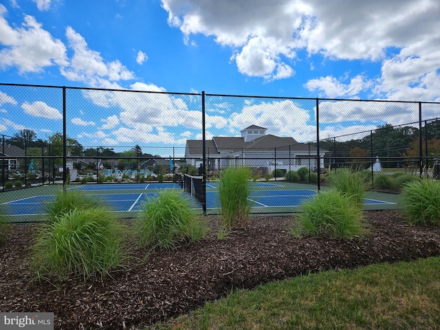 view of tennis court featuring fence