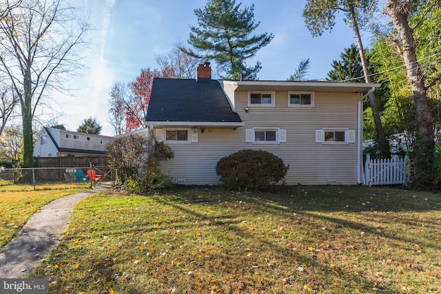 back of property featuring a lawn