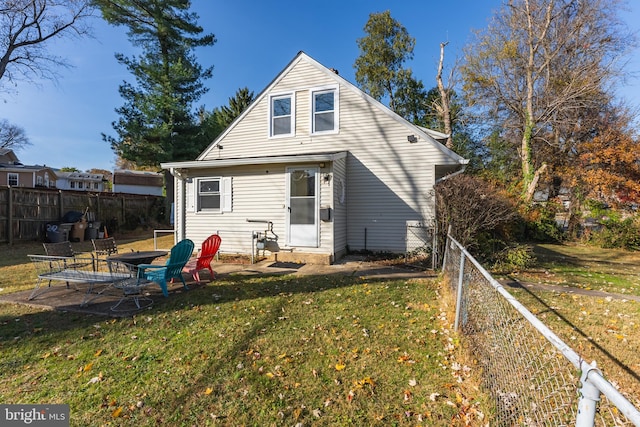 rear view of house featuring a yard and a patio area