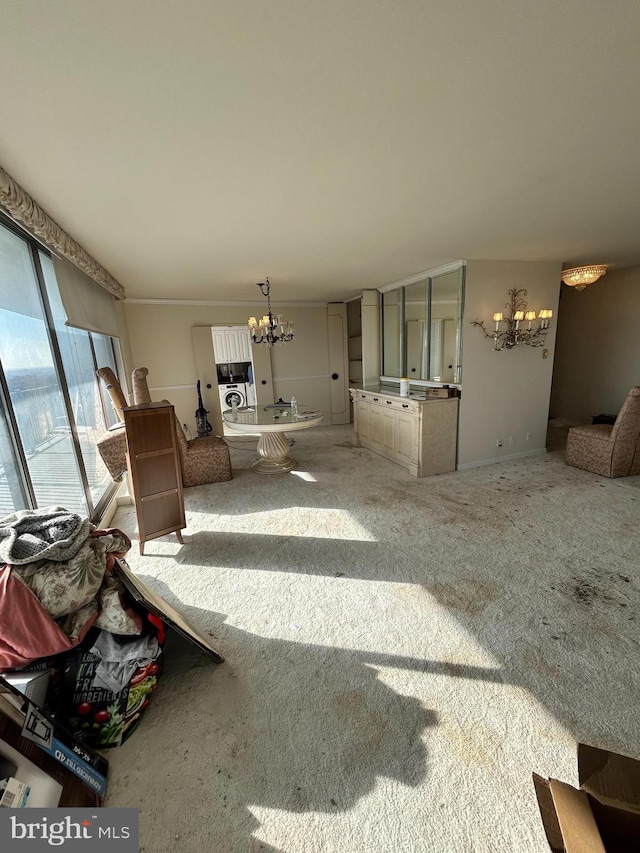 unfurnished living room featuring carpet flooring and an inviting chandelier