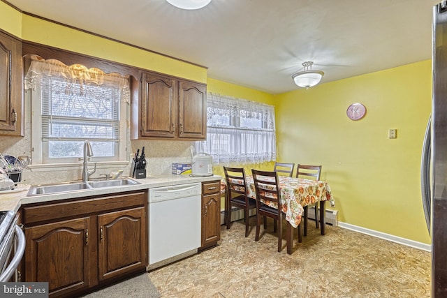 kitchen featuring baseboard heating, sink, plenty of natural light, and appliances with stainless steel finishes