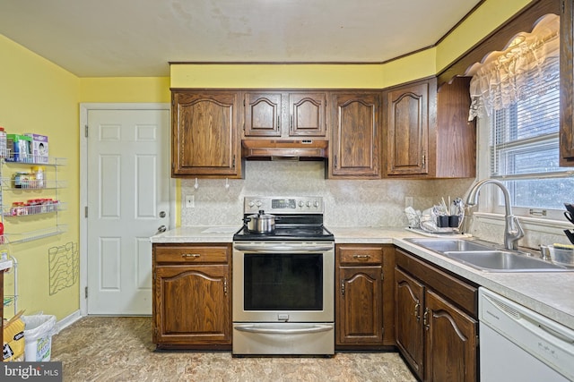 kitchen with stainless steel range with electric stovetop, premium range hood, white dishwasher, sink, and decorative backsplash