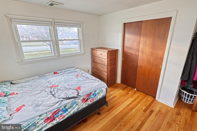 bedroom featuring a closet and light hardwood / wood-style floors