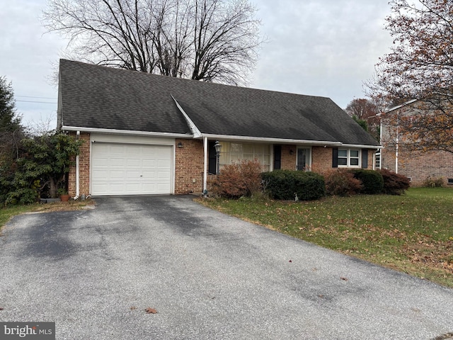 view of front of house featuring a front yard and a garage