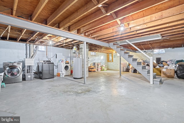 basement featuring gas water heater and washer and clothes dryer