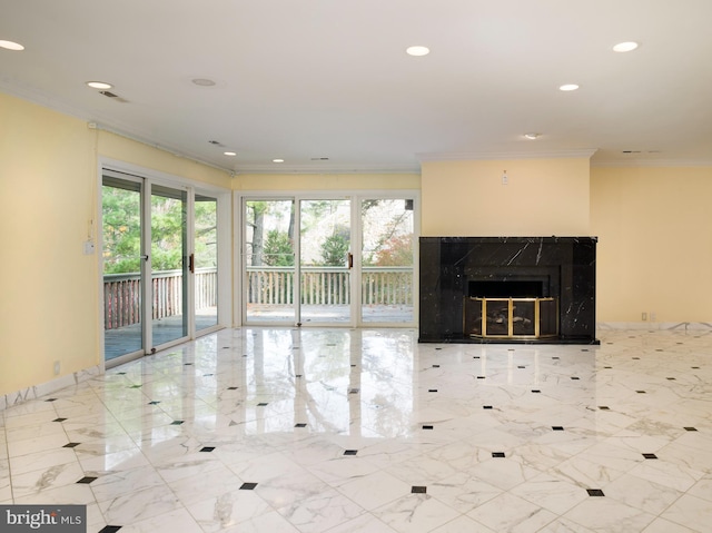 unfurnished living room featuring plenty of natural light, a premium fireplace, and crown molding