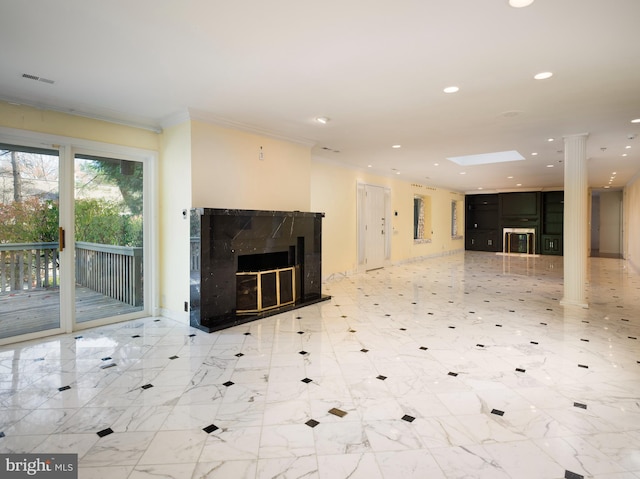 unfurnished living room featuring a high end fireplace and ornamental molding