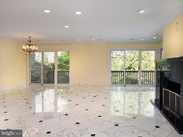 unfurnished living room with ornamental molding and a chandelier