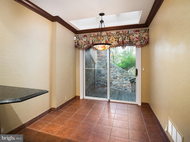 unfurnished dining area with a chandelier, ornamental molding, and a tray ceiling