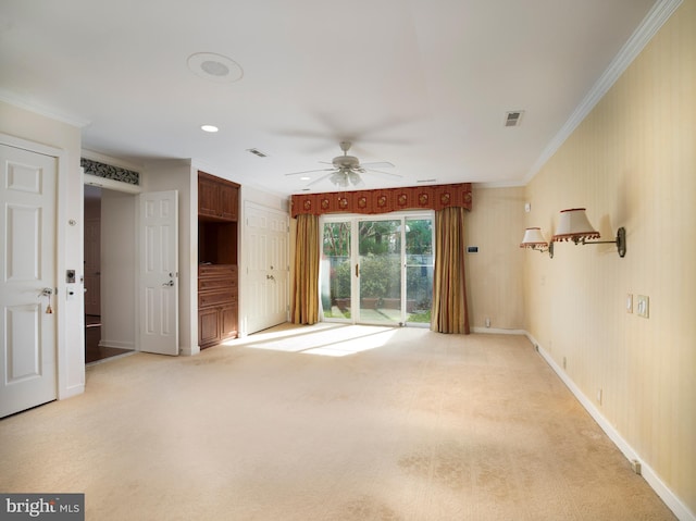 interior space featuring light colored carpet, ceiling fan, and ornamental molding