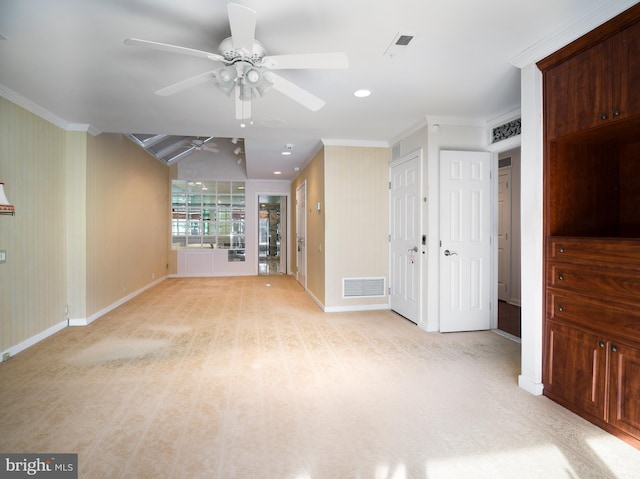 interior space with ceiling fan and crown molding