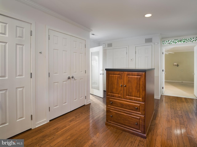 hallway featuring dark hardwood / wood-style floors and ornamental molding