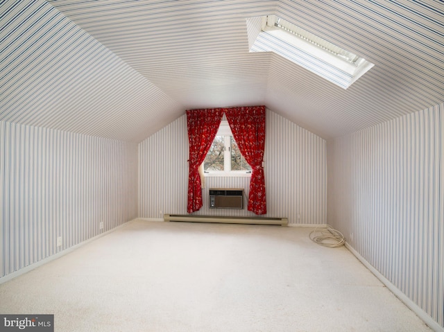 additional living space featuring a baseboard radiator and vaulted ceiling