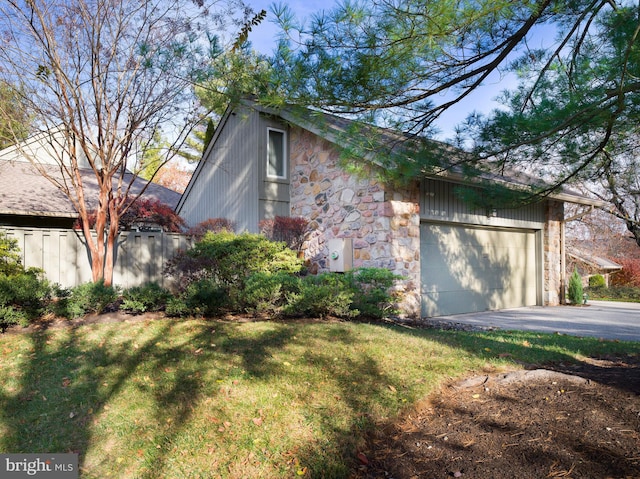 view of side of property featuring a yard and a garage