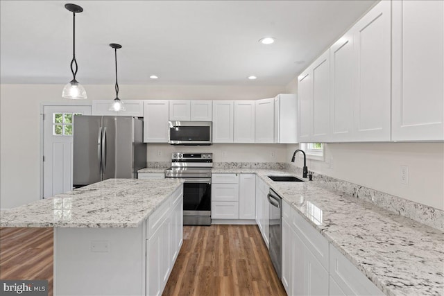 kitchen featuring sink, white cabinetry, stainless steel appliances, and a wealth of natural light