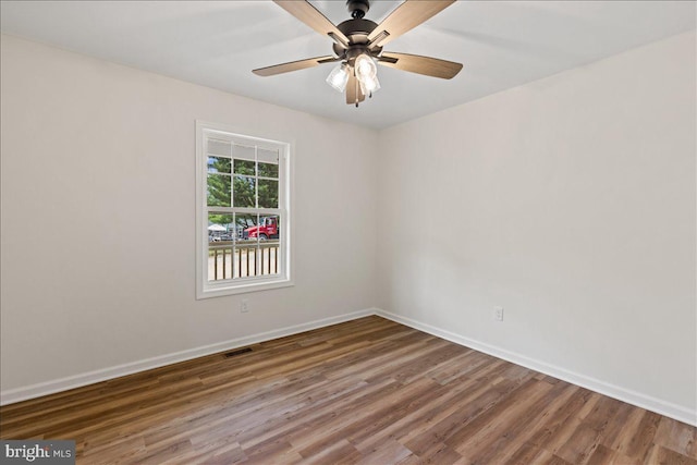 empty room with ceiling fan and wood-type flooring