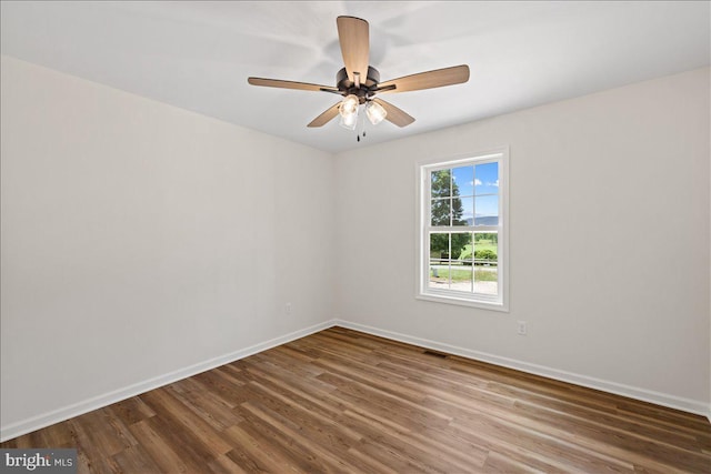 empty room with hardwood / wood-style flooring and ceiling fan