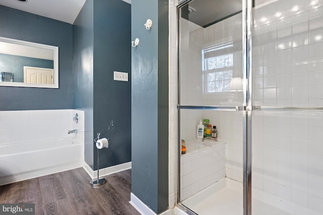 bathroom featuring hardwood / wood-style floors and plus walk in shower