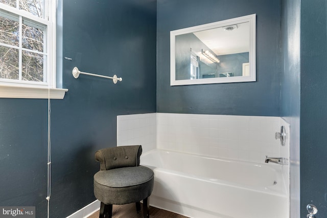 bathroom featuring hardwood / wood-style flooring and a tub