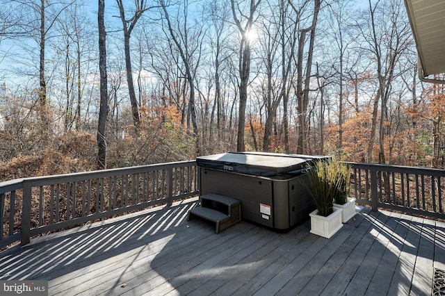 wooden deck featuring a hot tub