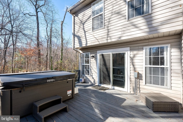 wooden deck featuring a hot tub