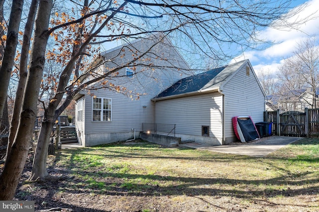 rear view of property featuring a lawn