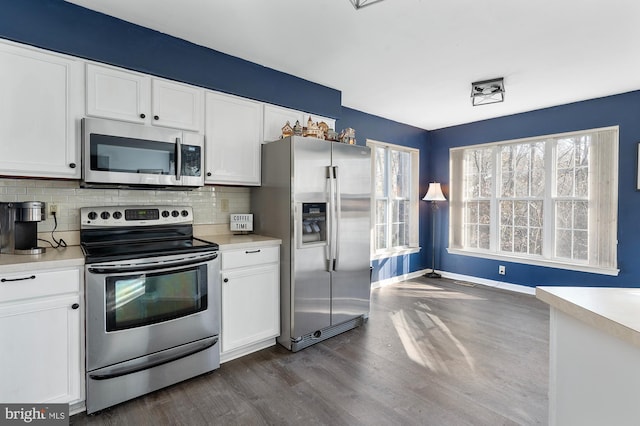 kitchen featuring backsplash, dark wood-type flooring, white cabinets, and stainless steel appliances