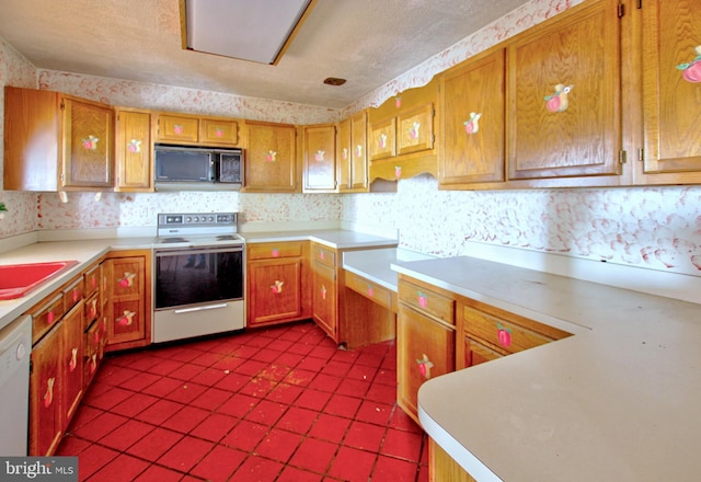 kitchen featuring dishwasher, light tile patterned flooring, sink, a textured ceiling, and electric range oven