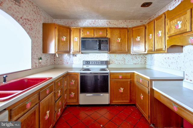 kitchen with stainless steel electric stove, sink, a textured ceiling, and dark tile patterned flooring