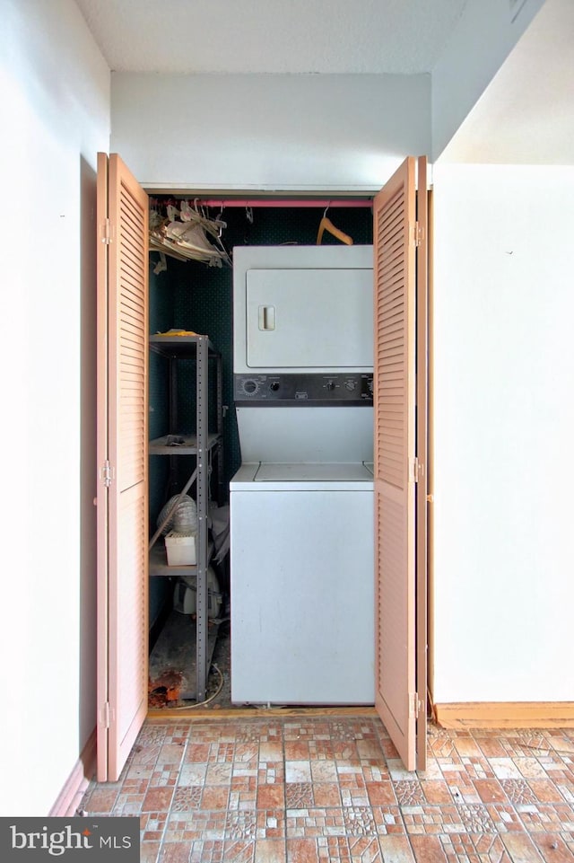 laundry area featuring stacked washing maching and dryer