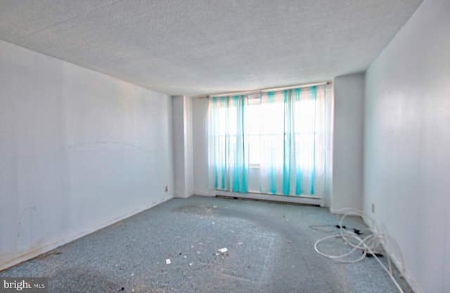 spare room featuring a textured ceiling