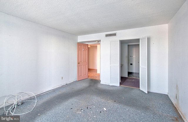 spare room featuring a textured ceiling