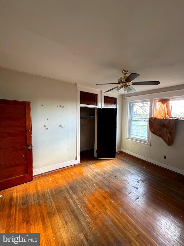 unfurnished bedroom featuring hardwood / wood-style flooring and ceiling fan