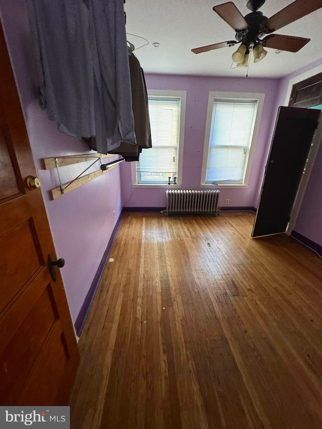 interior space with wood-type flooring and radiator