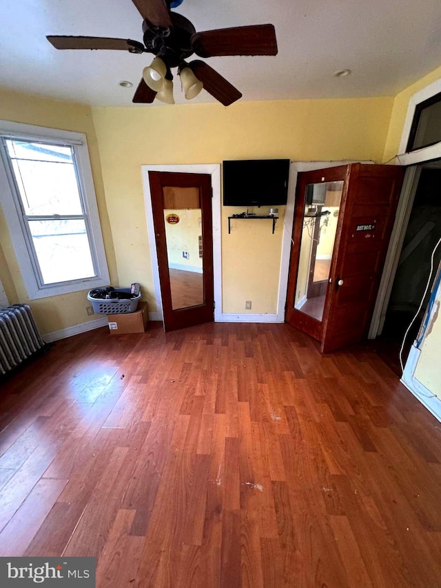 unfurnished room featuring hardwood / wood-style floors and ceiling fan