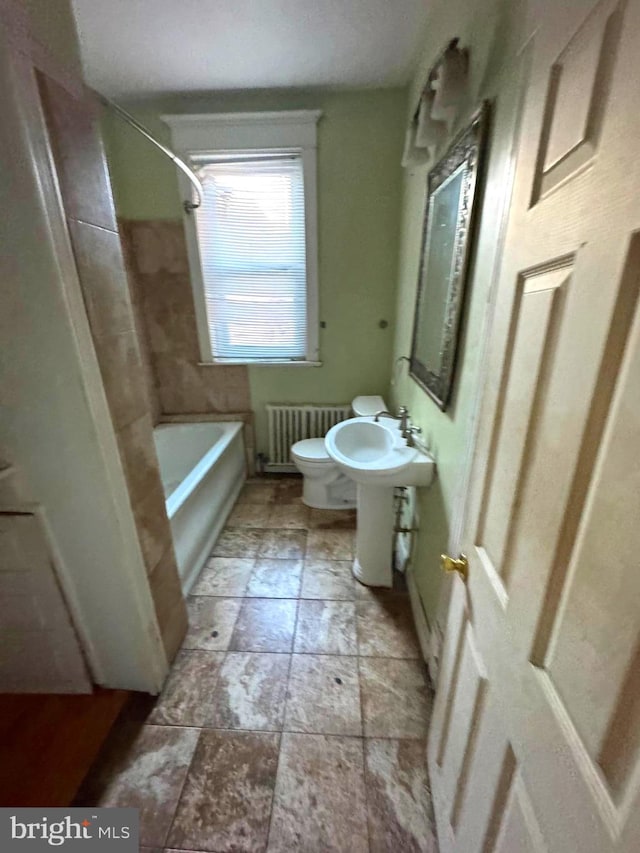 bathroom featuring shower / tub combination, radiator, and toilet