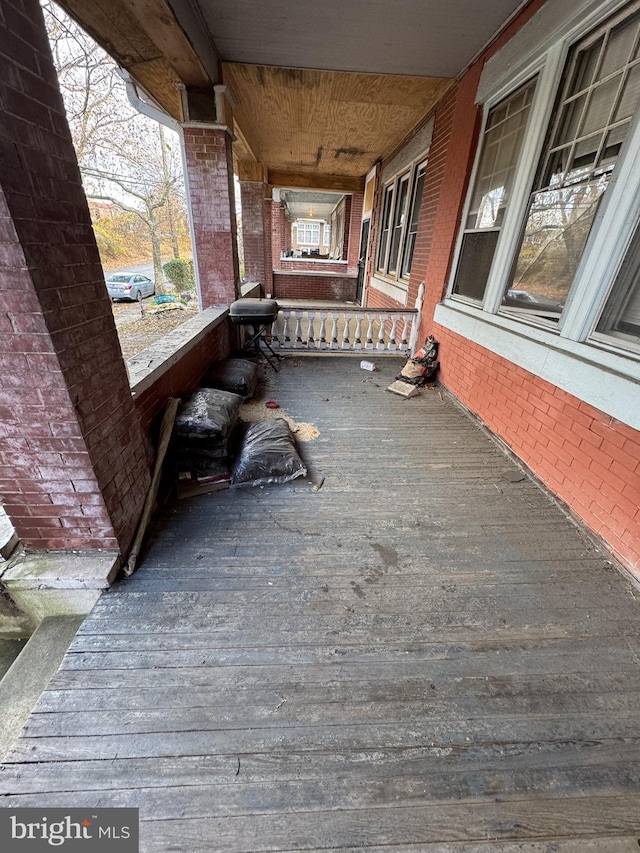 wooden deck featuring cooling unit