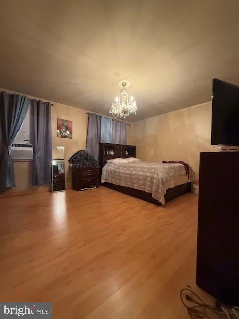 bedroom featuring a chandelier, hardwood / wood-style floors, and cooling unit