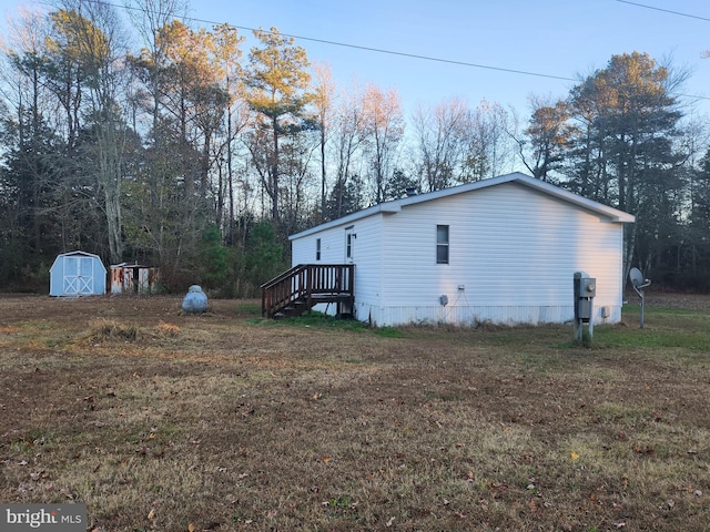 view of home's exterior featuring a yard and a storage shed