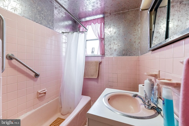 bathroom featuring shower / tub combo with curtain, vanity, and tile walls