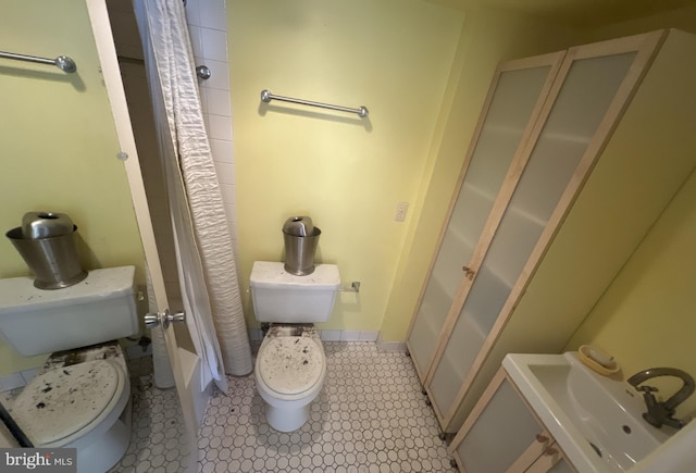 bathroom with a shower with shower curtain and toilet