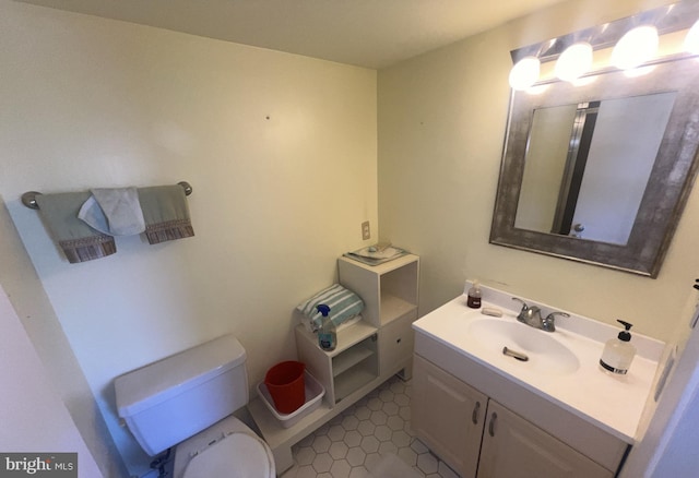 bathroom featuring tile patterned floors, vanity, and toilet