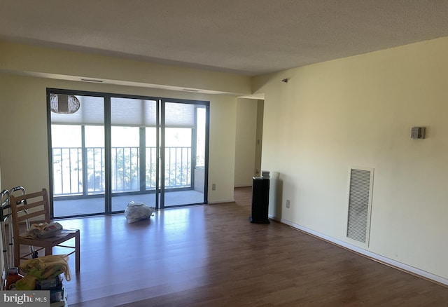 living room featuring a textured ceiling and dark hardwood / wood-style floors