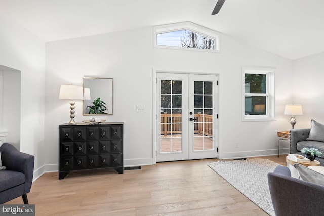 sitting room featuring lofted ceiling, french doors, and light hardwood / wood-style flooring