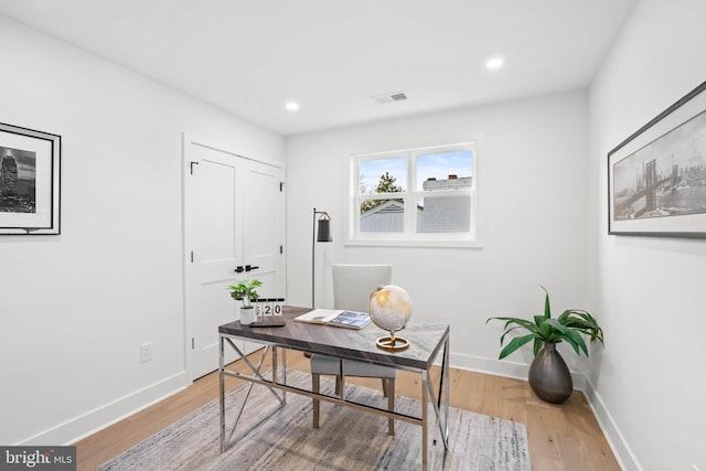 office with light wood-type flooring