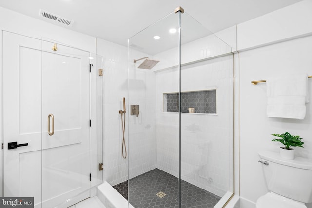 bathroom with toilet and walk in shower