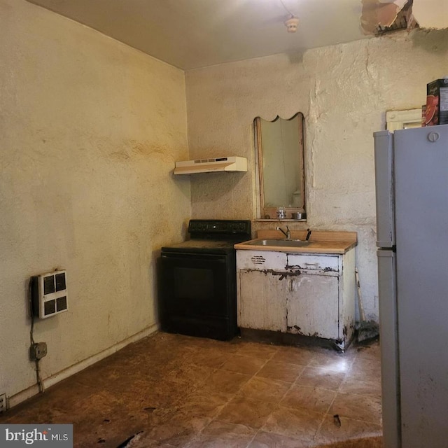 kitchen featuring sink, black range with electric cooktop, white fridge, extractor fan, and heating unit